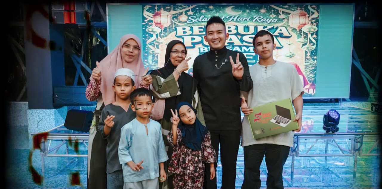 Boss A presenting a laptop to a family